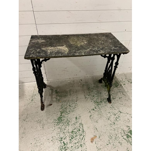 249 - A garden table with cast metal frame (92cm x 46cm)