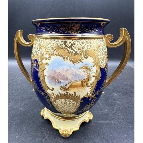 261 - A Coalport two handled vase, cobalt blue with gilt decoration and hand painted scenes. 13cm High