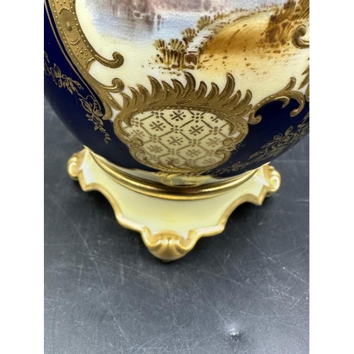 261 - A Coalport two handled vase, cobalt blue with gilt decoration and hand painted scenes. 13cm High