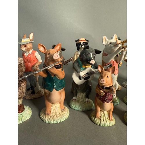 265 - A collection of Beswick figures to include a eight piece pig band