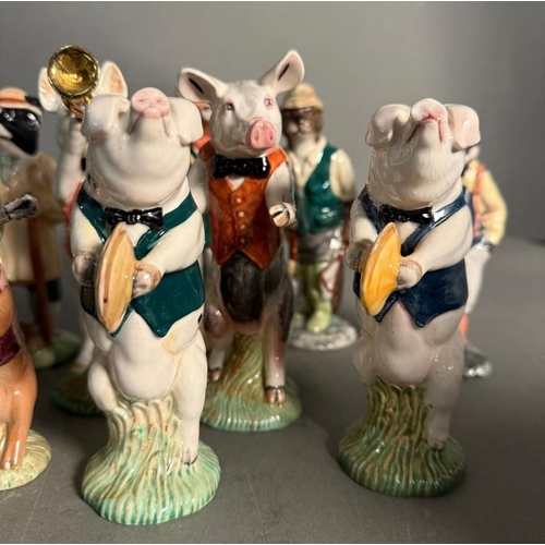 265 - A collection of Beswick figures to include a eight piece pig band