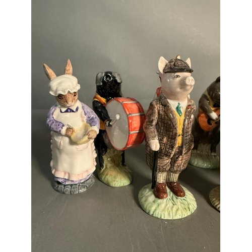 265 - A collection of Beswick figures to include a eight piece pig band