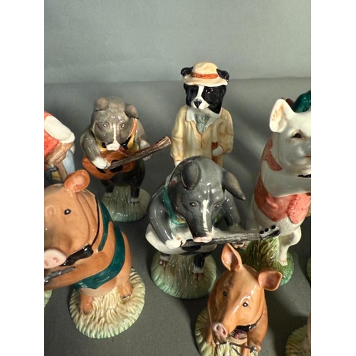 265 - A collection of Beswick figures to include a eight piece pig band