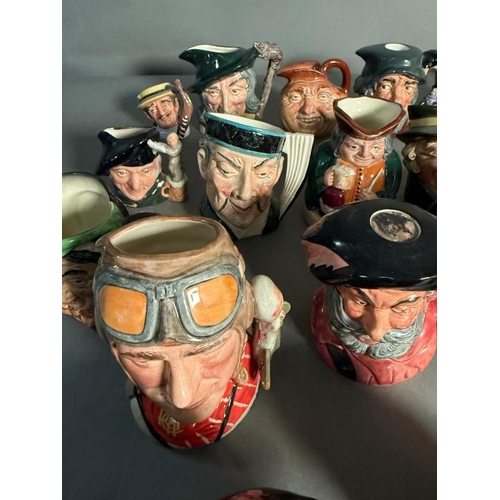 275 - A collection of miniature Royal Doulton character jugs to include John Bull, The Airman and The Mika... 