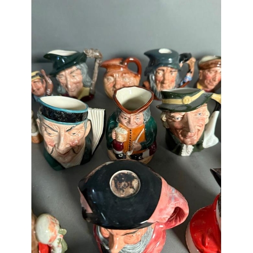 275 - A collection of miniature Royal Doulton character jugs to include John Bull, The Airman and The Mika... 