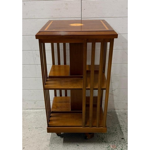 28 - An Edwardian inlaid mahogany revolving bookcase (H86cm W46cm D46cm)