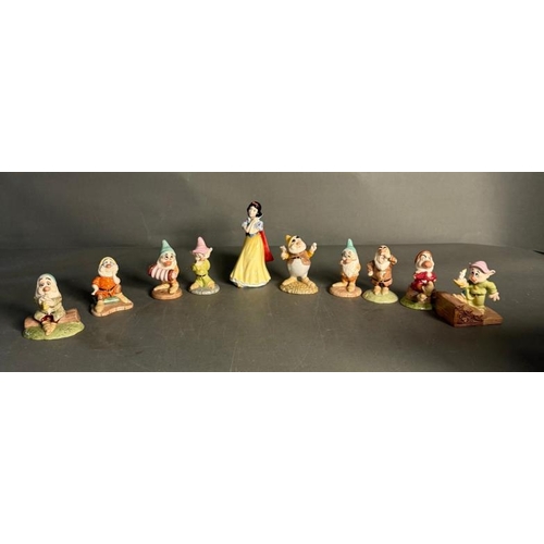 285 - A Royal Doulton Snow White and The Seven Dwarfs with an additional two dwarves