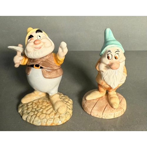 285 - A Royal Doulton Snow White and The Seven Dwarfs with an additional two dwarves