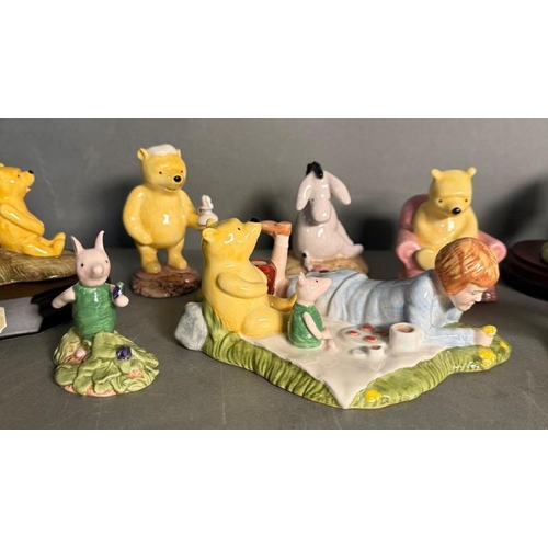 286 - A selection of Royal Doulton figures to include The Honeypot, Christopher Robin and Kanga and Roo