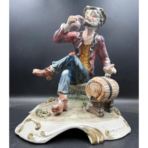 292 - A Capo Demonte figure of a seated man with a barrel of drink