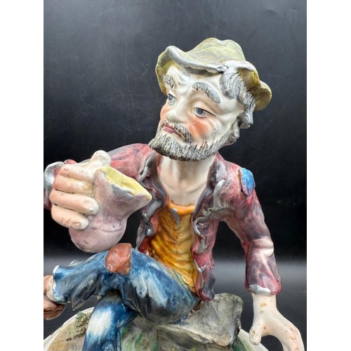 292 - A Capo Demonte figure of a seated man with a barrel of drink