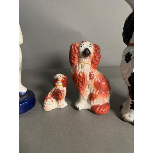 296 - A selection of Staffordshire spaniels in various colours