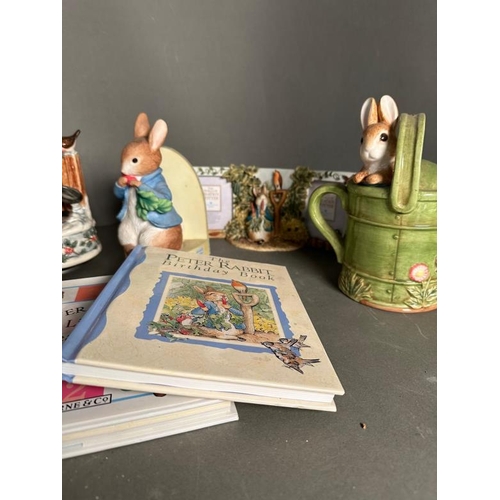 339 - A selection of Bextrix Potter Peter Rabbit collectable to include money boxes, books and a tea pot