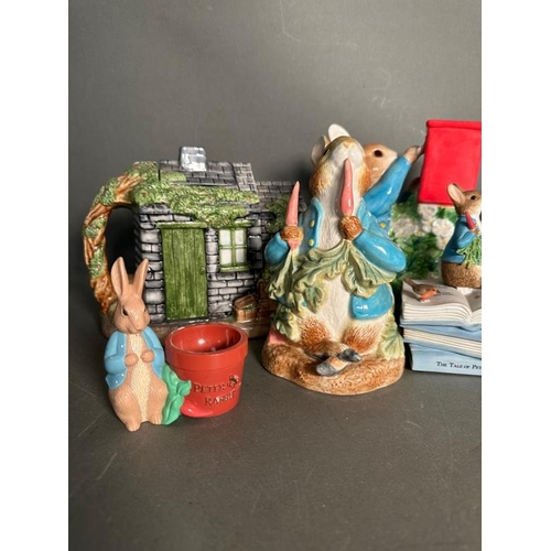 339 - A selection of Bextrix Potter Peter Rabbit collectable to include money boxes, books and a tea pot