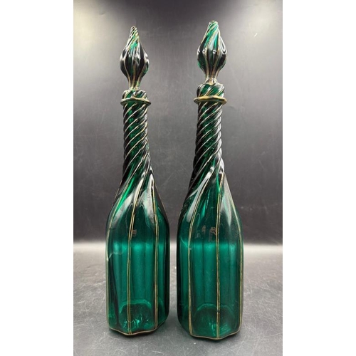 347 - A pair of green Continental Genie style glass decanters with gold detail and twisted design.