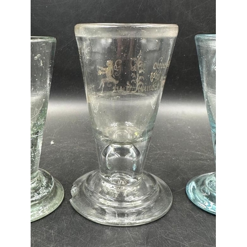 348 - Three 18th Century firing glasses one with German etched design