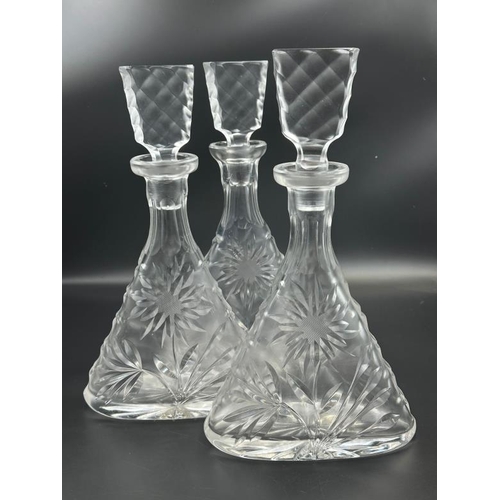 351 - A set of three cut glass decanters with sunflower design, approximate height 31cm