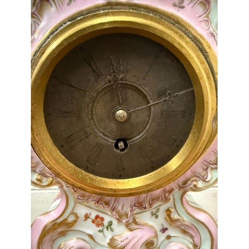 384 - A Dresden style ceramic mantle clock painted with a floral central shield and sides