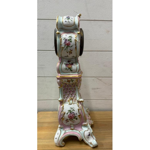 384 - A Dresden style ceramic mantle clock painted with a floral central shield and sides