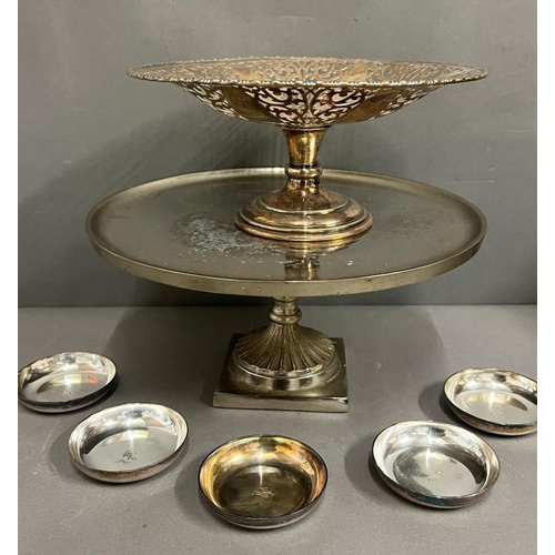 402 - Two footed stands and a set of five small white metal dishes