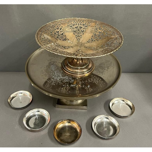 402 - Two footed stands and a set of five small white metal dishes