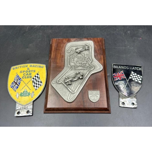 403 - Motorsport collectables, two enamel badges for the B.R.D.C and Brands hatch and a plaque of silver s... 