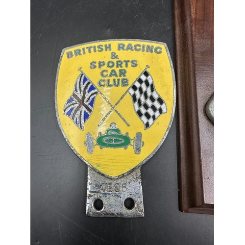 403 - Motorsport collectables, two enamel badges for the B.R.D.C and Brands hatch and a plaque of silver s... 