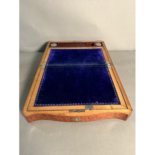 409 - A walnut writing slope with mother of pearl central inlay. The lid openning to a purple velvet writi... 