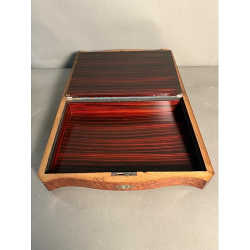 409 - A walnut writing slope with mother of pearl central inlay. The lid openning to a purple velvet writi... 