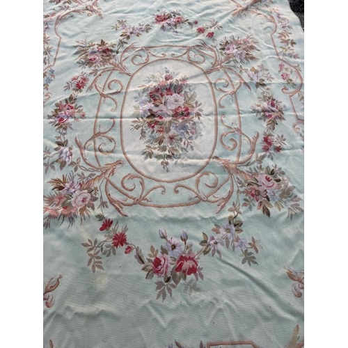 423 - A wall hanging embroidery green grounds with floral, central shield and border 277cm x 193cm