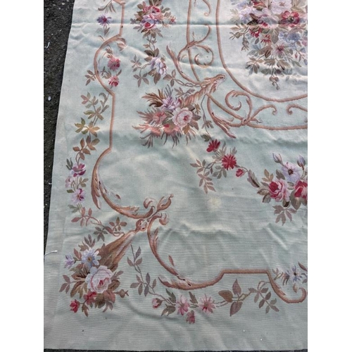 423 - A wall hanging embroidery green grounds with floral, central shield and border 277cm x 193cm