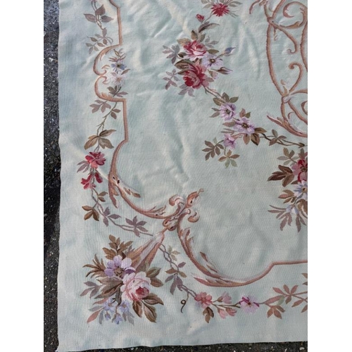 423 - A wall hanging embroidery green grounds with floral, central shield and border 277cm x 193cm