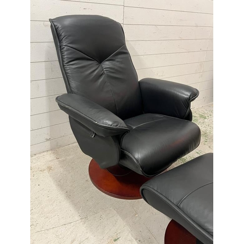 47 - A leather swivel recliner chair with foot stool