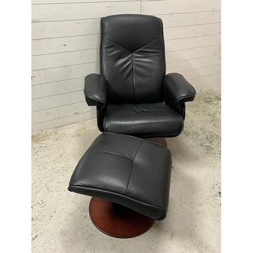 48 - A leather swivel recliner chair with foot stool