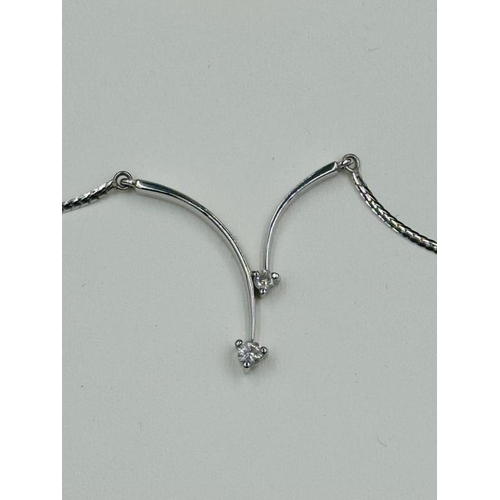 494 - A 9ct white gold necklace with integral diamond pendant, approximate weight 4.7g