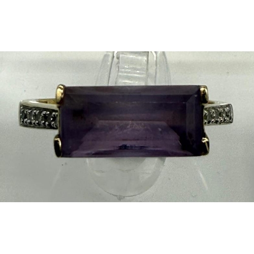 500 - A 9ct gold fashion ring with purple stone and diamond shoulders, approximate weight 2.7g and size Q