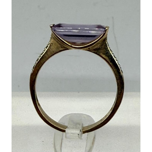 500 - A 9ct gold fashion ring with purple stone and diamond shoulders, approximate weight 2.7g and size Q