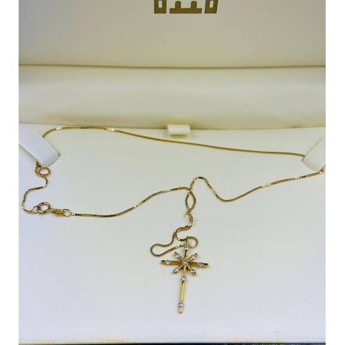 549 - A Royal Mints Classics 18ct gold cross and necklace in original box with an approximate weight of 3.... 