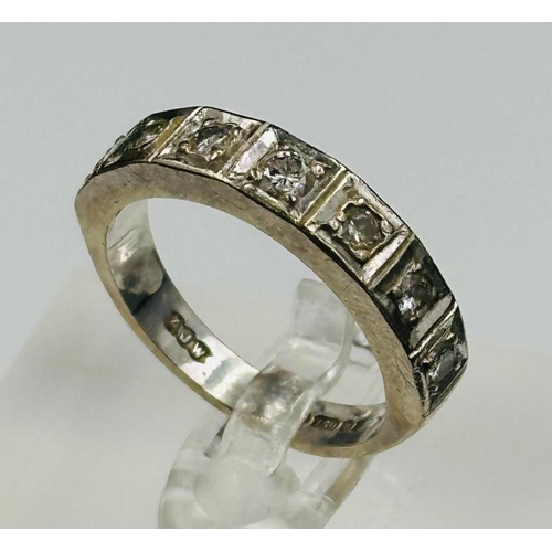 562 - An 18ct white gold and diamond half eternity style ring, approximate style N and weight 6.3g