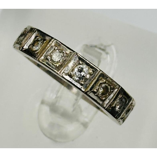 562 - An 18ct white gold and diamond half eternity style ring, approximate style N and weight 6.3g