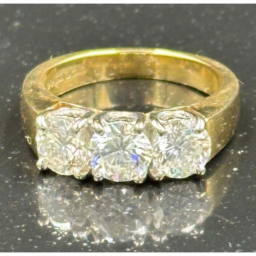 577 - A three stone diamond ring, mounted in 18ct yellow and white gold, London hallmarked, EF maker, cent... 