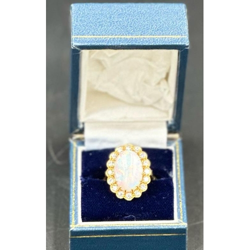 579 - An 18ct Opal and diamond ring, approximate size N 1/2