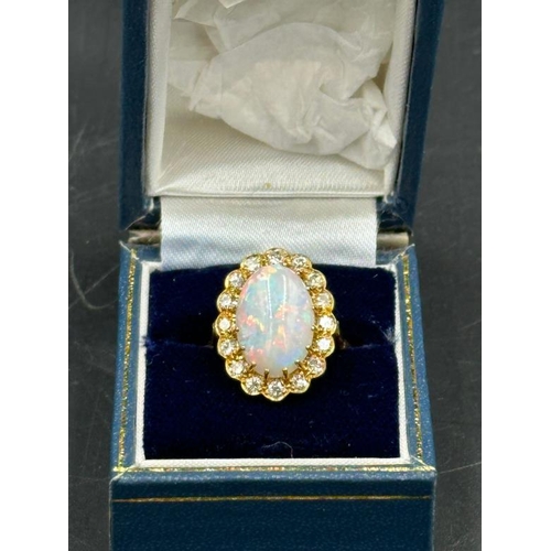 579 - An 18ct Opal and diamond ring, approximate size N 1/2