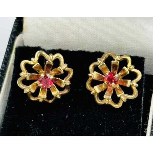 586 - A pair of 9ct gold earrings with central stone in a floral design, approximate total weight 2.9g