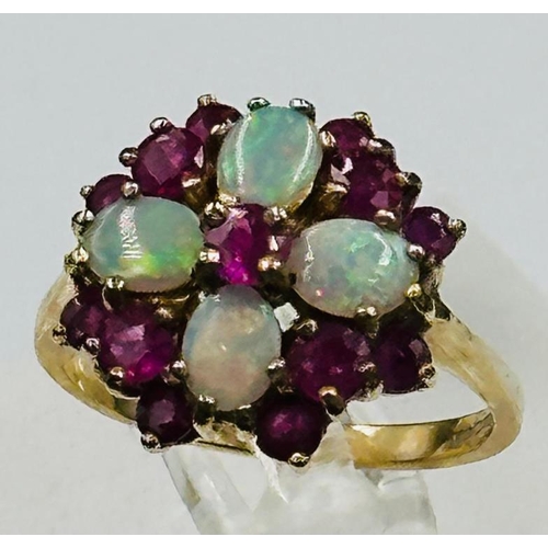 588 - A 9ct gold opal and ruby ring, approximate size O and weight 3.9g