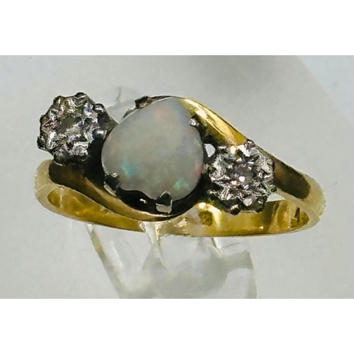 605 - An opal and diamond ring. centre heart shaped opal with diamond shoulders on an 18ct yellow gold set... 