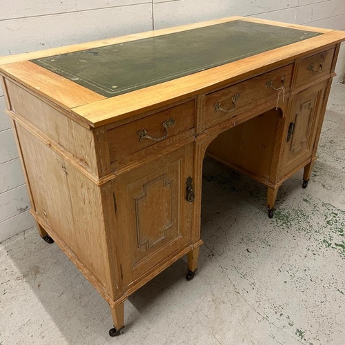 61 - A light oak desk with leather top (H77cm W166cm D60cm)