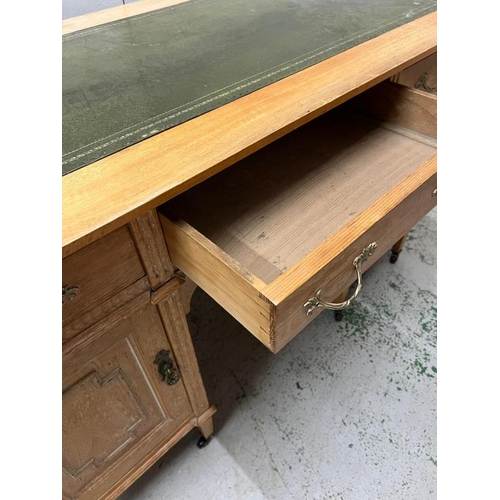 61 - A light oak desk with leather top (H77cm W166cm D60cm)