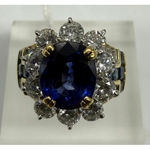 627 - A Contemporary Sapphire , diamond oval cluster ring. Central stone approximate 4.10ct Burma origin s... 