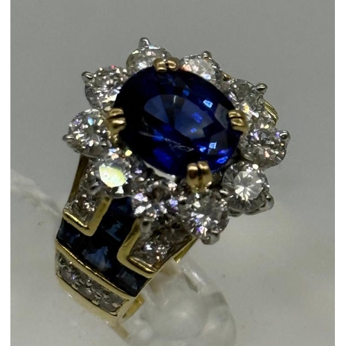 627 - A Contemporary Sapphire , diamond oval cluster ring. Central stone approximate 4.10ct Burma origin s... 